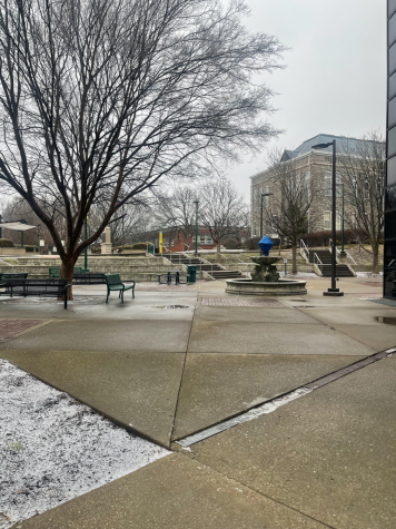 The concrete outside of the Carl M. Hill Student Center is wet from melted ice that left puddles in certain areas.  
